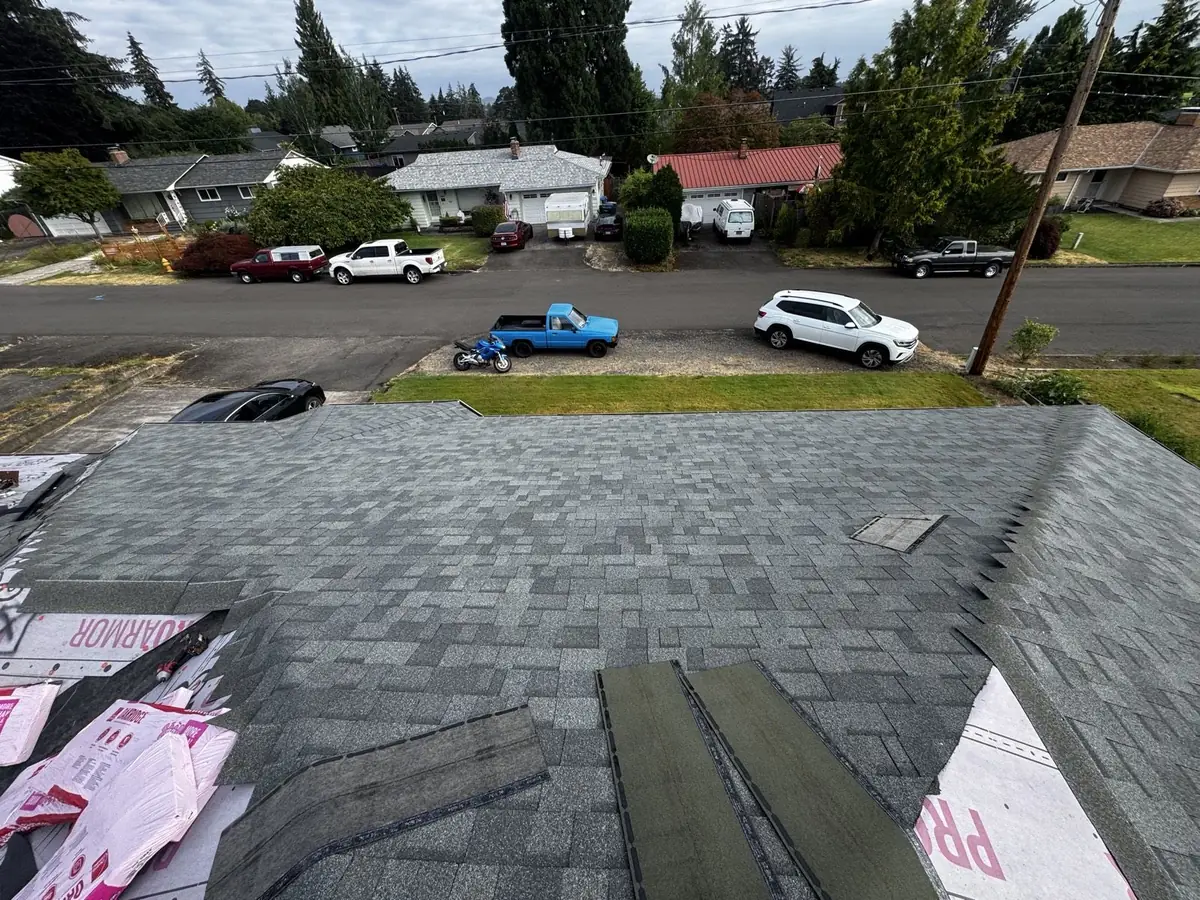 Shingle field and staged ridge caps during a Mistletoe Construction roof replacement in Douglas County Oregon
